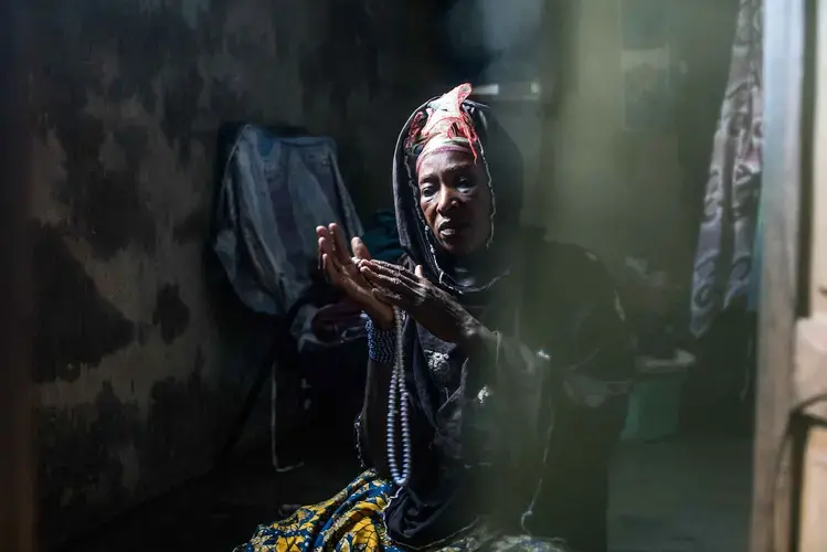 Traoré’s mother, Farima Ouatiara, prays in the bedroom of her home in Kolondiéba. Image by Nichole Sobecki. Mali, 2017.