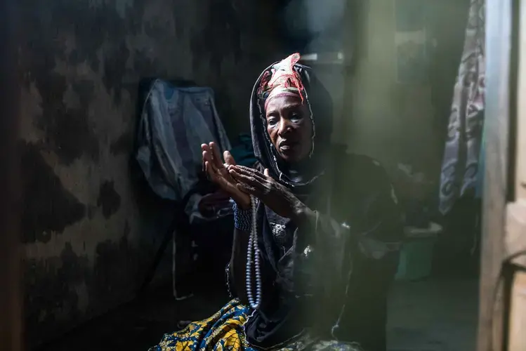 Traoré’s mother, Farima Ouatiara, prays in the bedroom of her home in Kolondiéba. Image by Nichole Sobecki. Mali, 2017. 