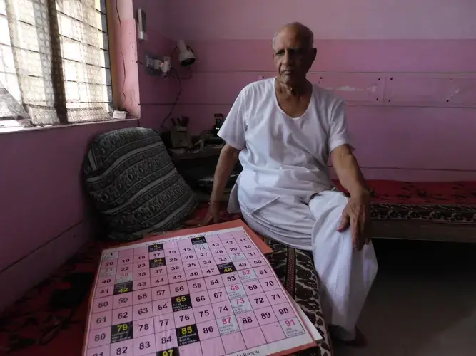 Health training consultant Kaushik Desai showcases one of several board games he created for adolescent sex education. Image by Ambar Castillo. India, 2017.