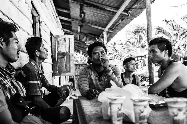 MEETING. Palm oil workers meet to discuss their work conditions in the plantation. Image by Xyza Cruz Bacani. Indonesia, 2018. 