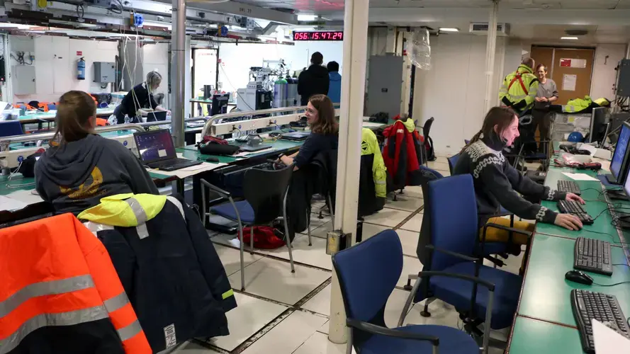 Some of the science team onboard the R/V Alliance. During the first leg of the project, the harsh weather caused the ship to roll, sending tables sliding across the lab. Image by Ari Daniel. Iceland, 2018.