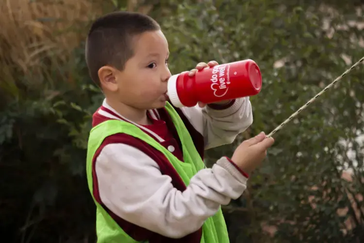 United Health Care distributed free water bottles at the soccer clinic at Carroll Elementary school in Bernalillo, New Mexico. One of the Notah Begay III Foundation most important goals is to reduce the consumption of sugary beverages in kids. Image by Viridiana Vidales Coyt. United States, 2017.