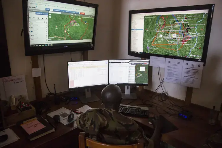 Inside the park’s control room, where software plots ranger movement, bush fires and other crucial information on a Google Earth map. Image by Jack Losh. Central African Republic, 2018.