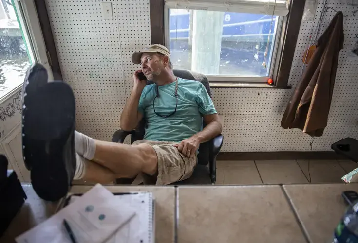 Roscoe Liebig at his bait shop at Pass Christian Harbor. Image by Eric J. Shelton for Mississippi Today. United States, 2019.