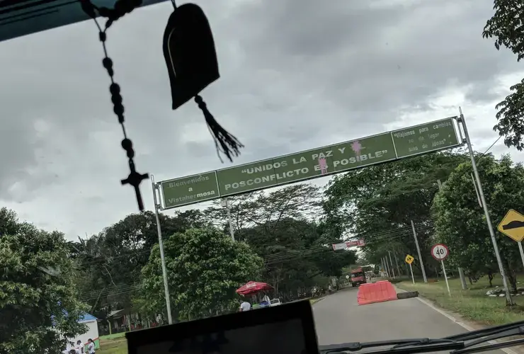 A sign saying unity and peace in the post-conflict is possible is defaced with paint on the main road into Vista Hermosa, Meta, Colombia on Thursday, March 8, 2018. Image by Greg Kendall-Ball. Colombia, 2018.