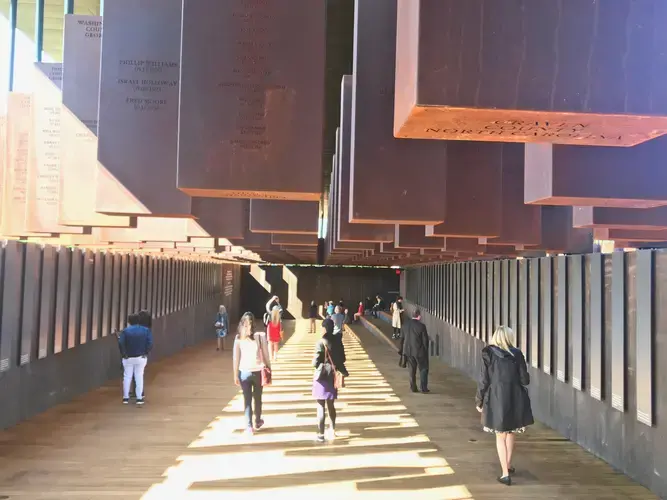 Names and dates of victims, by county, at the National Memorial for Peace and Justice in Montgomery, AL. Image by Jon Sawyer. United States, 2018. 