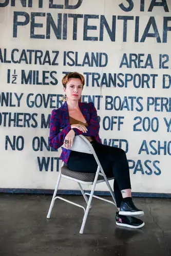 Journalist and artist Sarah Shourd sits for a portrait in a building on Alcatraz Island. Image by Gabrielle Lurie. United States, 2019.