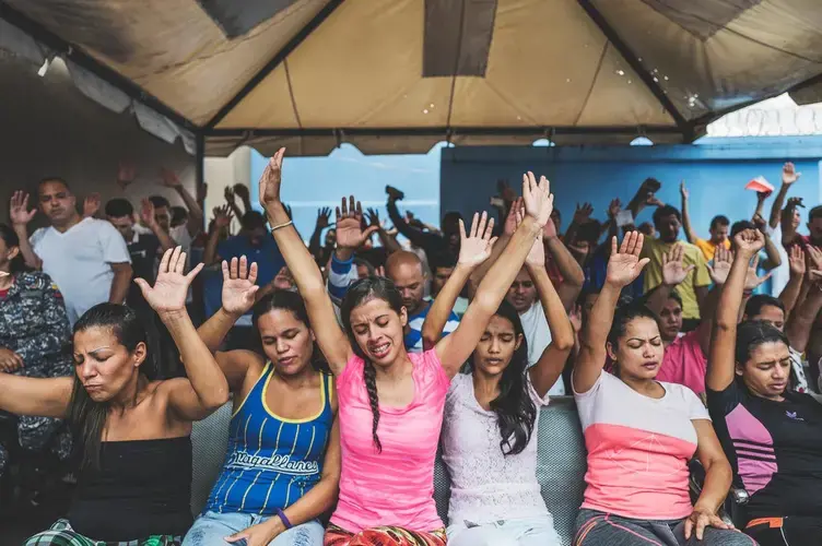 Male and female detainees attend an evangelical service at La Yaguara Detention Center, Caracas, where a preacher discussed forgiveness and reflection, followed by a religious play and a shared meal. Image by Ana María Arévalo. Venezuela, 2018.