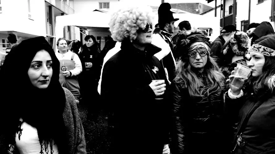 Wesam Daas, left, with Carnival revelers in Altenmarkt, Bavaria. Image by Frank Hessenland. Germany, 2017.