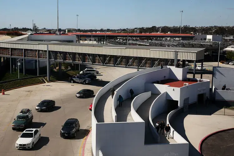 A zigzag ramp carries pedestrians over Tijuana’s main border crossing, El Chaparral. Asylum-seekers can apply to enter the U.S. at this station. Image by Erika Schultz. Mexico, 2019.