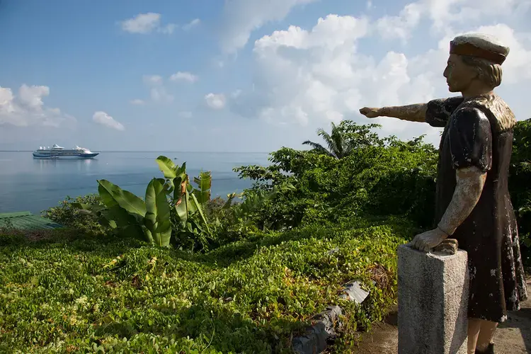 A statue of Christopher Columbus on a lookout in Trujillo points to the spot where the explorer first landed on mainland Central America. Image by Susan Meiselas/Magnum Photos. Honduras, 2018.