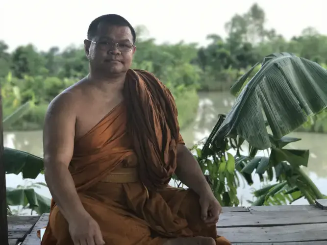 Phrakhu Sangkom Thanapanyo Khunsuri gives a speech to the villagers of Surin on the importance of trees and stopping deforestation. Image by Kiley Price. Thailand, 2018