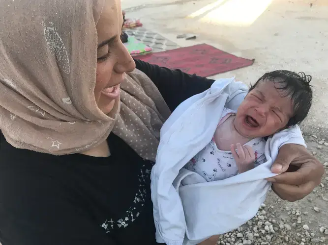 Batoul led her toddler and her husband out of Raqqa while eight-months pregnant. Now, she is focused on her baby’s future while living at Ayn Issa camp for the displaced. Image by Jon Gerberg/PBS NewsHour. Syria, 2017.