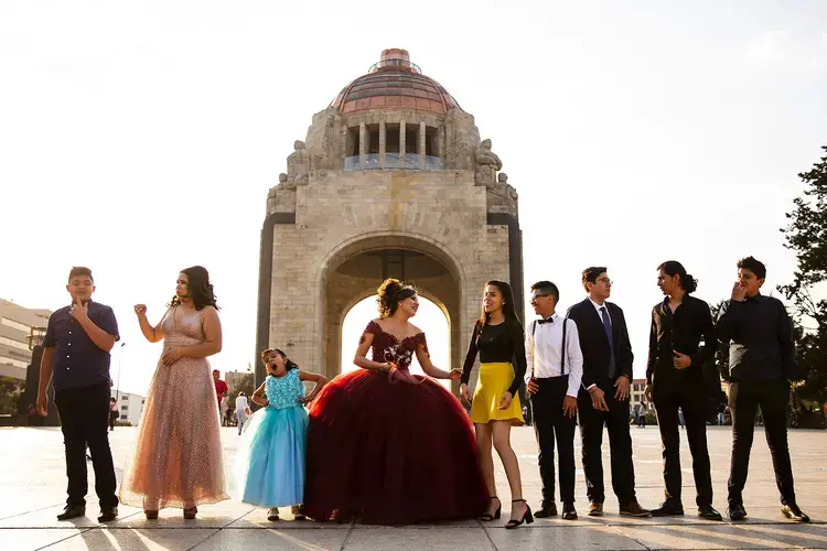 Leslie Valeria, center, prepares for a photo session for her quinceañera at Monumento a la Revolución in Mexico City. Image by Erika Schultz. Mexico, 2019.