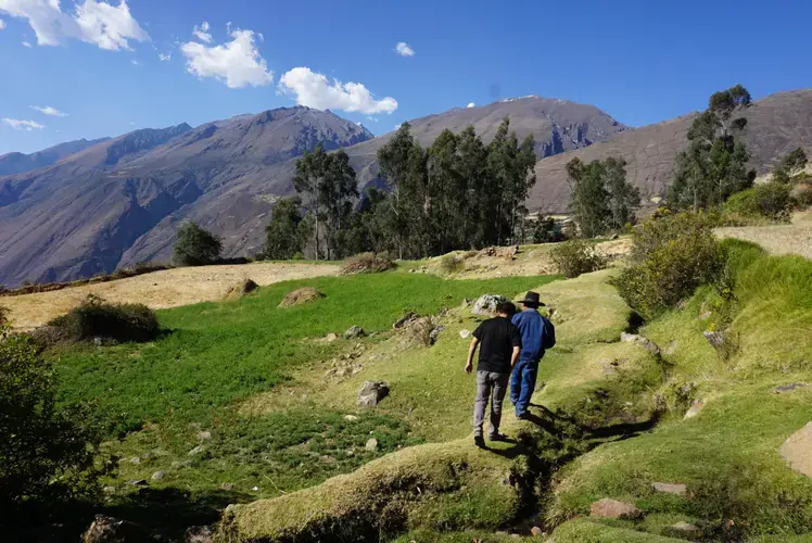 Gabino leads Clinton as the two observe their changing land. Image by Audrey Fromson. Peru, 2019.