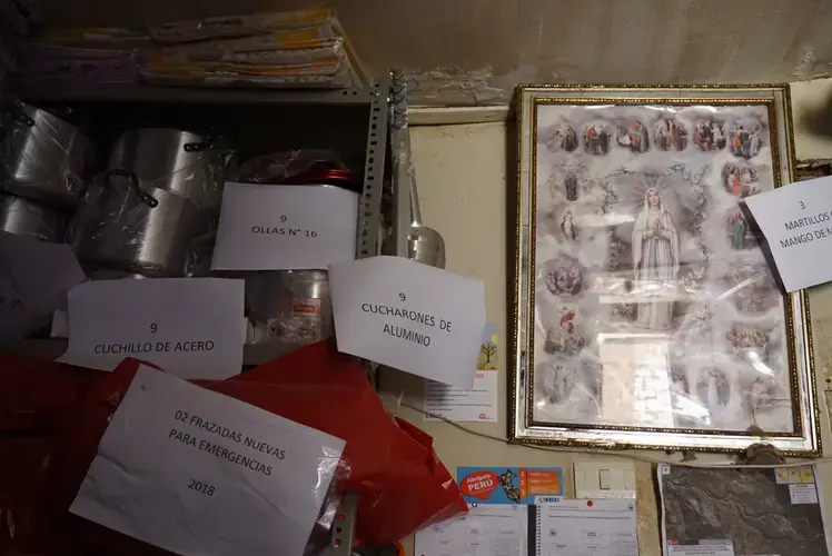 Emergency resources including pots, blankets, and canned food line the shelves of Jorge’s office. Image by Audrey Fromson. Peru, 2019.