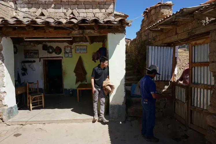 Clinton (center) works in Huaraz, but makes the three-hour journey to visit his parents in their village once a month. Image by Audrey Fromson. Peru, 2019.