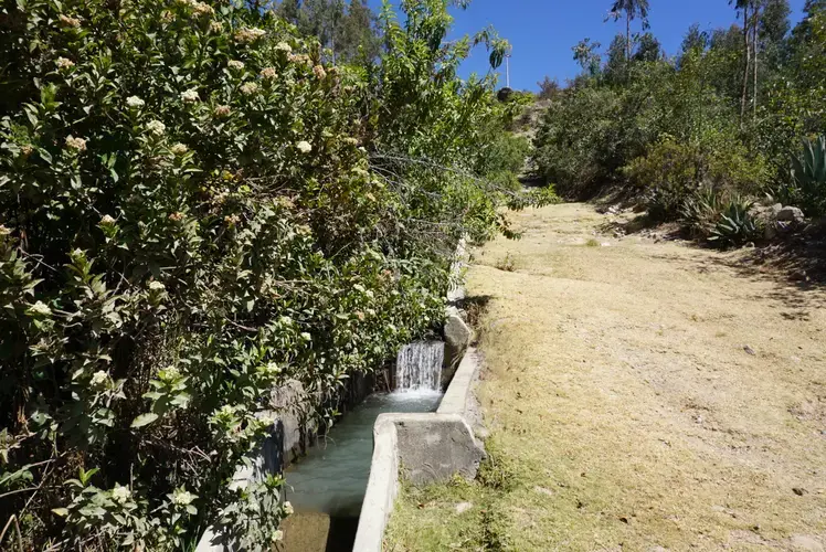One of the canals that delivers water to nearby communities. Water is intended to flow to the top of the cement walls. Image by Audrey Fromson. Peru, 2019.