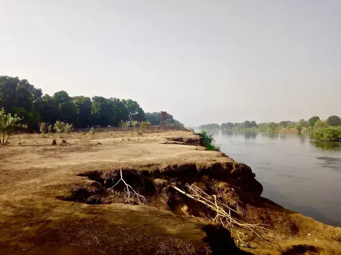 A concrete perimetre wall that stretches into the River Nile waters. Image by Paul Jimbo. Sudan, 2019.