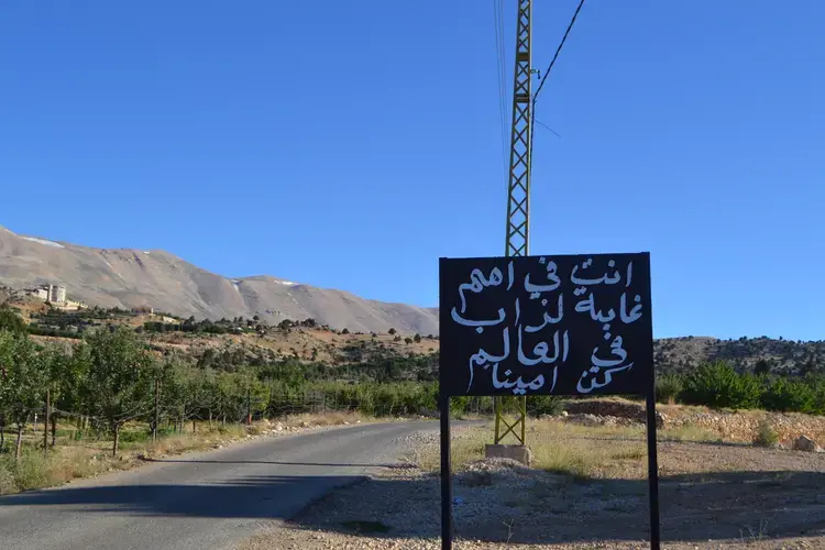 A sign welcomes visitors to the Kingdom of Junipers. Image by Catherine Cartier. Lebanon, 2019.<br />