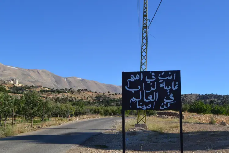 A sign welcomes visitors to the Kingdom of Junipers. Image by Catherine Cartier. Lebanon, 2019.<br />
