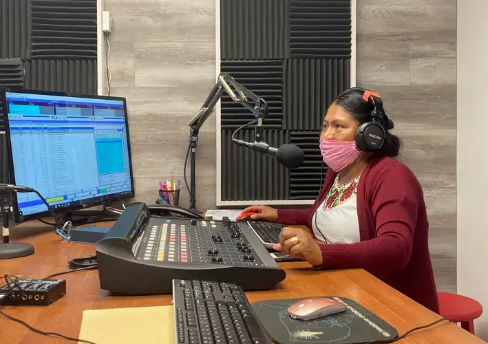 Lidia López prepares to go on-air from Radio Indígena's programming booth in Oxnard in July. Image by Julia Knoerr. United States, 2020.