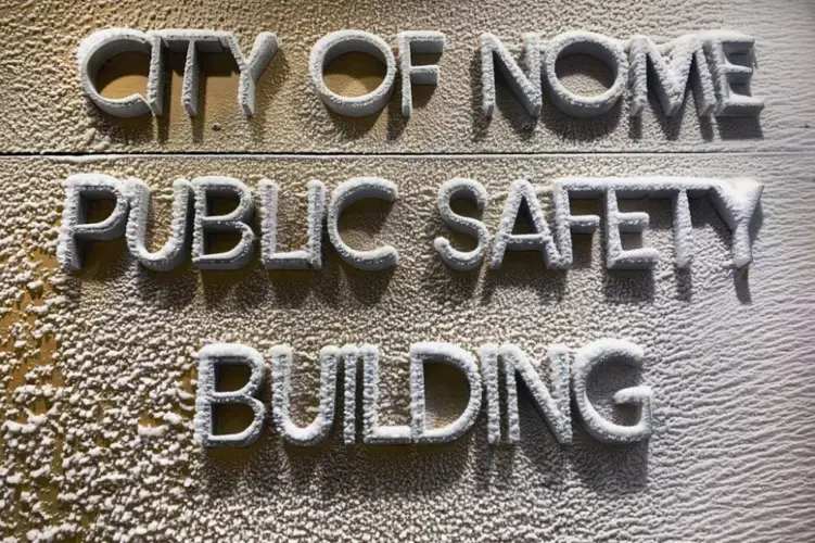 In this Feb. 21, 2019, photo, a snow-encrusted sign marks the entrance to the police station located on a tundra road on the outskirts of Nome, Alaska. According to city officials, several cabinets of police records were either lost or destroyed in the move to this building a decade ago. Image by Wong Maye-E. United States, 2019.