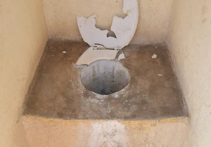 A pit toilet at Utjane that is in poor condition. Image by Adam Yates. South Africa, 2018.