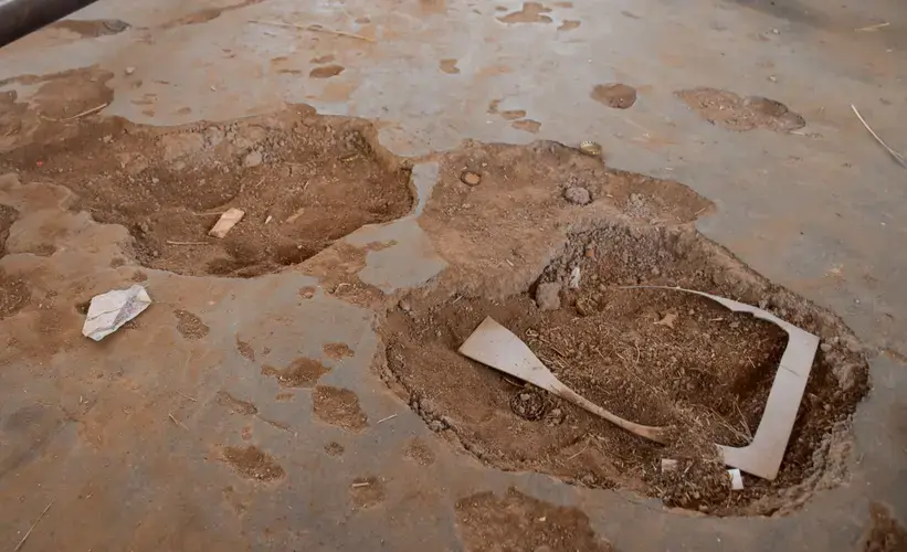 Cracks in the classroom floor pose 'a real danger to our health because once the learner steps inside the class he or she can trip and fall down. One of the learners can get injured,' said Malwanedick Malwane, a grade 12 student at Khwara Secondary School. Image by Adam Yates. South Africa, 2018.