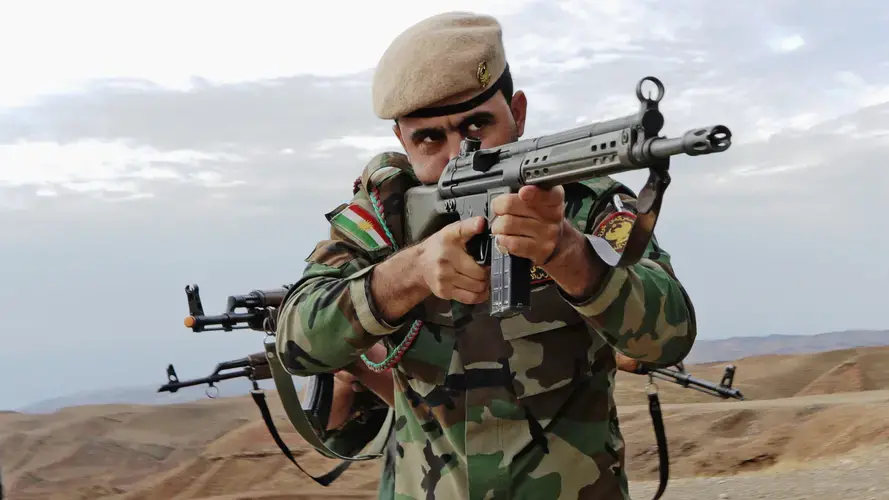 A Kurdish peshmerga soldier takes the lead during urban combat maneuvering training held near Erbil. Image by Spc. Tristan Bolden / U.S. Army. Iraq, 2015.