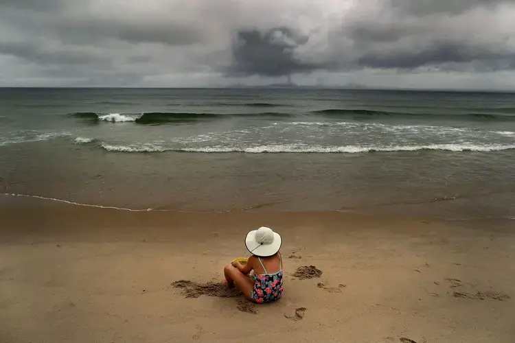 Salome Verkoville, 10 from Boston sits on Nauset Beach. Image by John Tlumacki. United States, 2019.