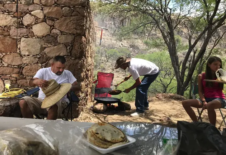 Rafael grills meat at a family picnic on Father’s Day. image by Nina Shapiro. Mexico, 2019.