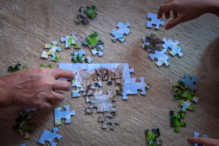 Milad and his family put together a puzzle. He told Markosian he never had puzzles in Afghanistan. Image by Diana Markosian. Germany, 2017.