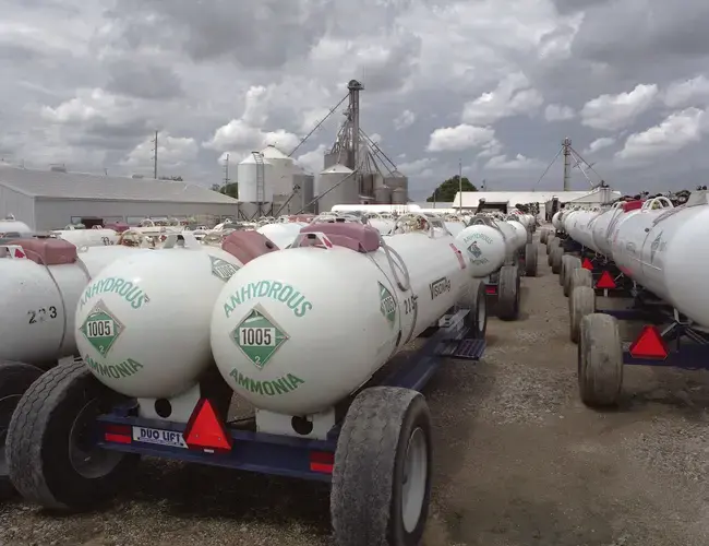 Keota, Iowa - Fertilizer trucks parked at Vision Agriculture. Alongside the Hypoxia Task Force’s promise to shrink the dead zone by 20 percent, Iowa’s Nutrient Reduction Strategy have also promised to make a 45 percent decrease in fertilizer runoff. Image by Spike Johnson. United States, 2019.