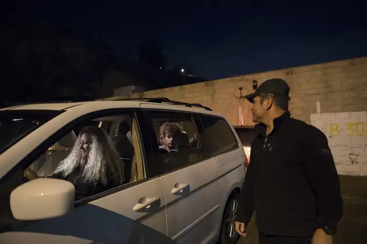 Enedis Flores, from left, gets set to drive her children across the Mexico border to Chula Vista, Calif., as Raymond and his siblings say goodbye to their father, Ramon. Image by Amanda Cowan. Mexico, 2019.