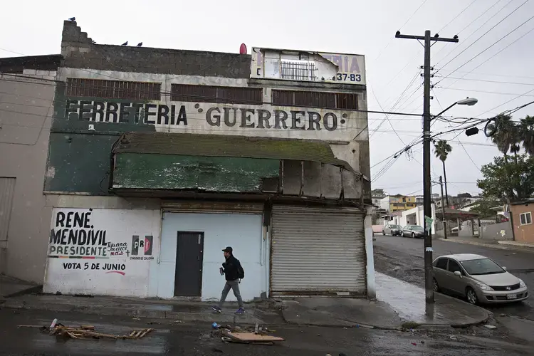 Ramon Flores walks from his car into the shop where he works as a carpenter Nov. 29 in Tijuana, Mexico. For decades, Ramon worked for Mexican grocery businesses, and in 2016, started his own full-time business when he lived in Hazel Dell. Image by Amanda Cowan. Mexico, 2019.