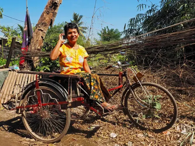 Mar Mar Aye and her daughter built a new business selling shoe soles by sending money and information via their phones. Image by Doug Bock Clark. Myanmar, 2017. 