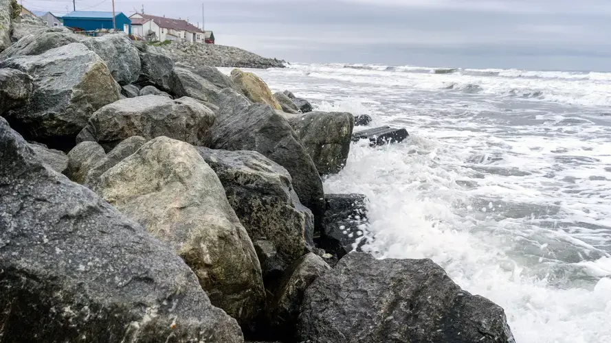 Waves from the Chuckchi Sea splash the seawall on the coast of Shishmaref. Image courtesy of Nick Mott. United States, 2018.