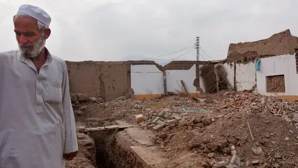 Shah Khan Kukikhel stands on the rubble of his brother's home near Jamrud, in the tribal areas of Pakistan. Image by Umar Farooq. Pakistan, 2017.
