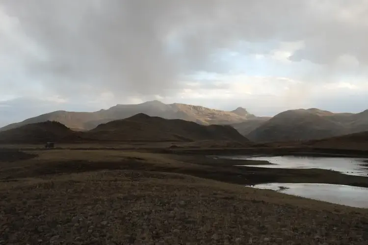 Rain drags across a lake built to store water in Tuco, a sub-community of Quispillaccta. Image by Dan Schwartz. Peru, 2019.