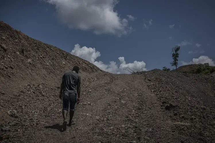 Li climbs up bare rock to the manganese mine that opened in 2016. Four years ago, this was a rainforest. The Batek’s water source sits below the mine, and they believe toxic runoff from the mine is contaminating it. Image by James Whitlow Delano. Malaysia, 2019.