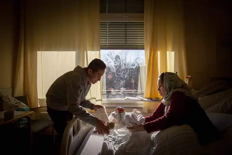 Milad’s mother holds her new daughter, Zeynab. “We all want to stay here, but I have no idea if we will,” Milad told Markosian. Image by Diana Markosian. Germany, 2017.