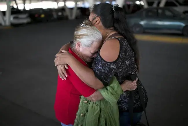Bertha Arias (left) cries as she says goodbye to Elena before walking to the international bridge to try to ask U.S. immigration authorities for permission to stay in the U.S. with her family as she waits for her asylum appeal. Image by Ivan Pierre Aguirre. Mexico, 2019.