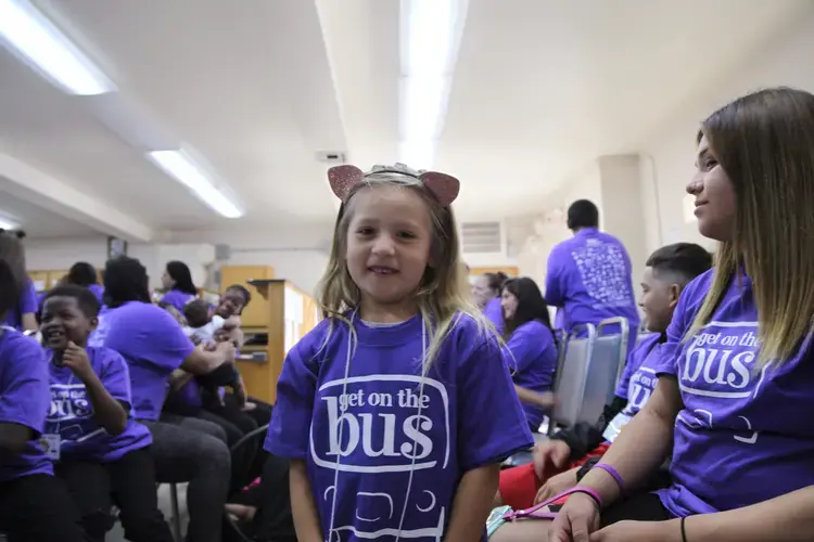 READY TO GO Rosary, 5, is excited to see her dad. (Folsom has separate prisons for men and women.) In this photo, she and others wait to check in. Visitors must show identification and go through security screening. Image by Jaime Joyce. United States, 2018.