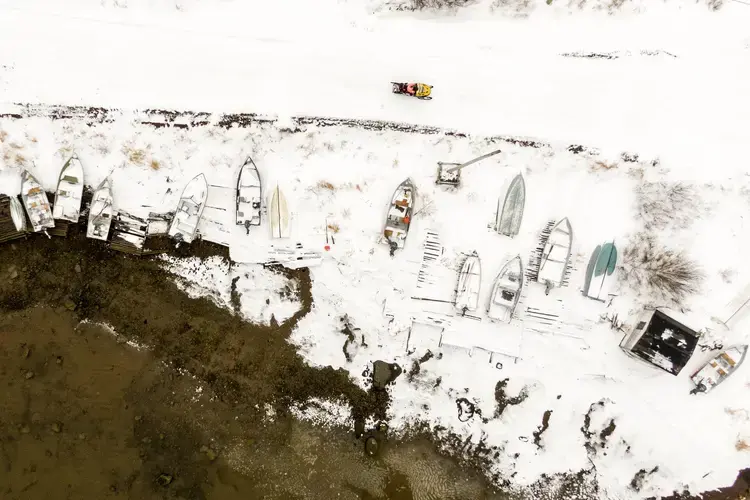 Fishing boats line the shore of Rigolet, a small Inuit town on Lake Melville northeast of Happy Valley-Goose Bay, Labrador. Image by Michael G. Seamans. Canada, 2019.