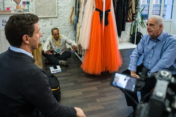 PBS NewsHour correspondent William Brangham (l) and Science magazine's Jon Cohen (seated) jointly interview UN Envoy Michel Kazatchkine for TV and print stories about HIV/AIDS in Russia. Image by Misha Friedman. Russia, 2017.