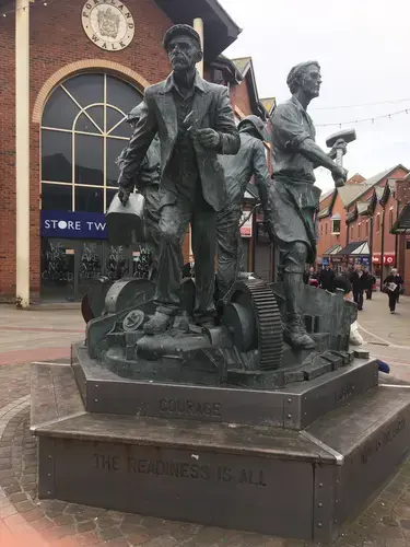 This monument to the heroic workers of the shipyard in Barrow was paid for by BAE Systems. It reads: 'COURAGE. THE READINESS IS ALL'. Image by Matt Kennard. United Kingdom, 2017.