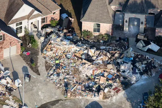 In Northwest Forest, a Beaumont, Texas subdivision close to Bevil Oaks, the entire contents of two houses have been shoveled into their front yards. Image by Alex MacLean. United States, 2017.