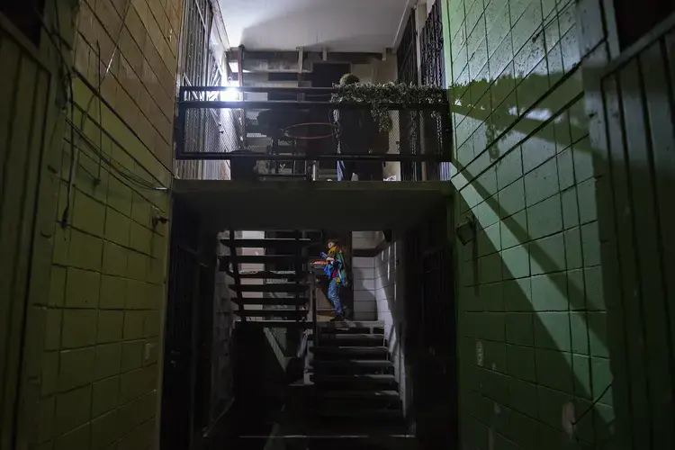 Edward Flores, 12, climbs the stairs to his father’s apartment in Tijuana, Mexico, after arriving shortly before midnight Nov. 27 for the Thanksgiving holiday. The family opted to cross the border at the San Ysidro Port of Entry as late as they could to avoid a backup of cars and long wait. Image by Amanda Cowan. Mexico, 2019.