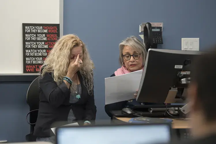 Enedis Flores shares a stressful moment with Professor Marcia Gibert after experiencing a brief technical difficulty with her final presentation in her reading class Dec. 3. Enedis, who has a part-time job and cares for six children while her husband is in Tijuana, Mexico, had stayed up until 10:30 the night before working on the project. She eventually earned an “A.” Image by Amanda Cowan. United States, 2019.